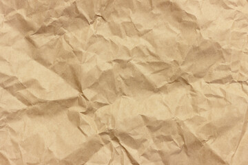 The texture of crumpled brown craft paper.