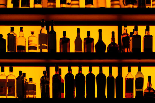 Rows of bottles sitting on shelf in a bar