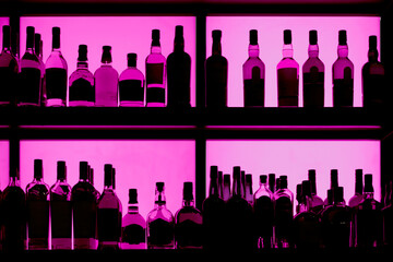Bottles sitting on shelf in a bar - obrazy, fototapety, plakaty
