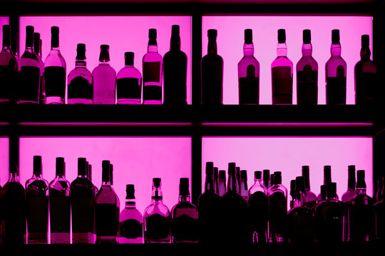 Bottles sitting on shelf in a bar