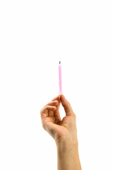 woman's hand holding a lit birthday candle on white background