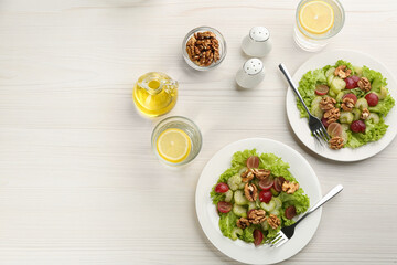 Delicious fresh celery salads served on white wooden table, flat lay. Space for text