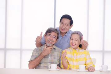 retired friends smile to camera together in living room