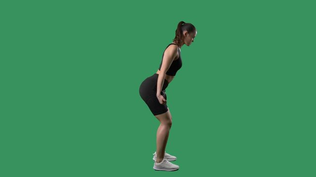Side view of athletic woman doing triceps and back kickback weight plate exercise. Full body on chroma key green screen. 