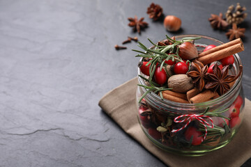 Aroma potpourri with different spices on black table, space for text