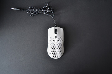 White gaming mouse on the black computer table © Marharyta