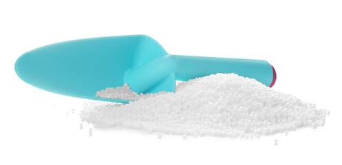 Pile of granular mineral fertilizer and scoop on white background