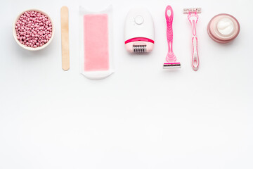 Epilation concept. Set of epilator with wax strips and razor, flat lay