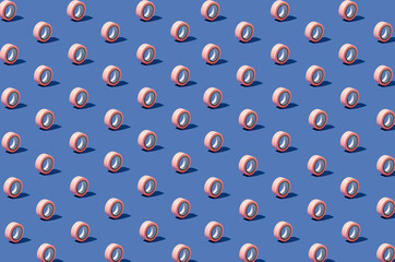 Creative isometric pattern made of pastel pink duct tape arranged on blue background. Minimal concept.