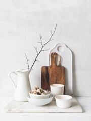 White and brown cottage kitchen decoration. Still life of various white dishes on a white background.