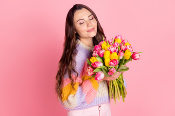 Portrait of attractive dreamy girl holding in hands smelling bunch tulips mom mother day event isolated over pink pastel color background