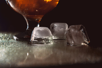 A glass of cognac on a dark background.