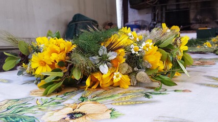 1st May traditional flower wreath from the side with crown daisies and other plants