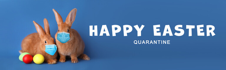 Text Happy Easter Quarantine and cute bunnies in protective masks on blue background, banner design. Holiday during Covid-19 pandemic