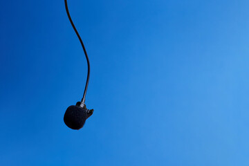 Background with clip-on microphone on blue background, flat lay. Top view. Audio chat, Podcast....