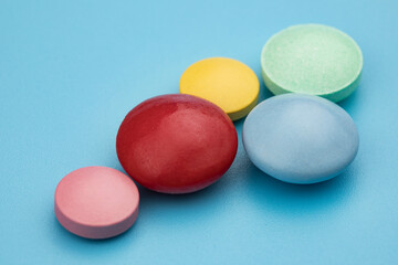 Multicolored tablets on blue background. Health care concept.