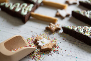 Homemade cookie in shape of Christmas tree and chocolate brownies decorated with sugar balls