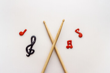 Drum sticks with music notes, overhead view. Music background