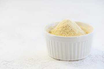 Chickpea flour in a white bowl. Horizontal orientation, copy space. 