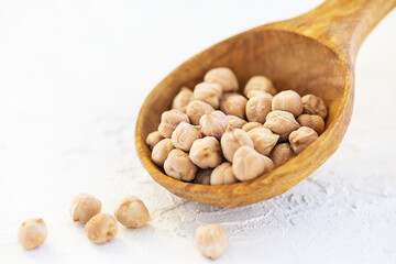 Chickpeas in a wooden spoon.