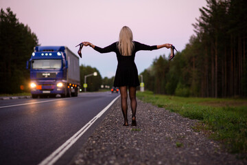 blonde goes barefoot on the highway, selective  focus