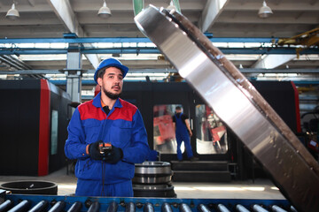 A worker controls the transport of a large diameter bearing. Bearing plant. Moving large diameter...