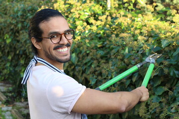 Young man using garden scissor