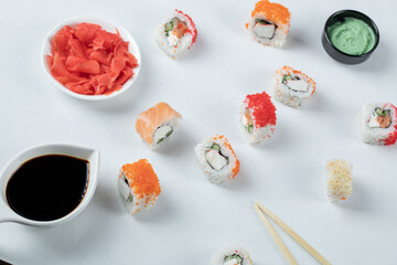 Variety of sushi rolls served with wasabi and soy sauce