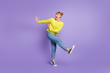 Fototapeta na wymiar Full length body size view of pretty cheerful carefree girl jumping having fun dancing isolated over pastel violet color background