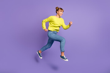 Fototapeta na wymiar Full length body size view of attractive cheerful girl jumping running fast isolated on bright violet color background