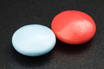 Multicolored tablets on black background. Health care concept.