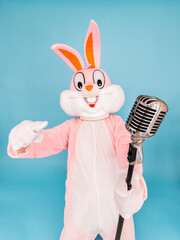 Positive funny man or kid singer or vocalist sings song to retro vintage classic microphone. Easter...