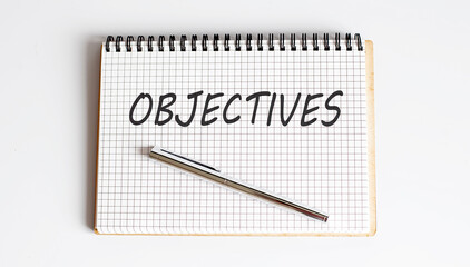 Text on notepad OBJECTIVES on white background. Business Concept