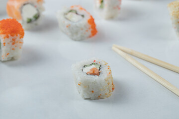 Maki sushi rolls with red caviar isolated on white background