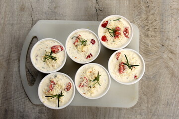 several dishes with casserole - sour cream, tomatoes and fish or other ingredients before baking. dishes with unroasted julienne 