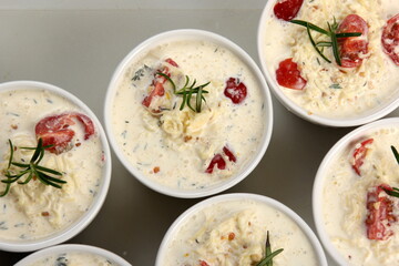 several dishes with casserole - sour cream, tomatoes and fish or other ingredients before baking. dishes with unroasted julienne 