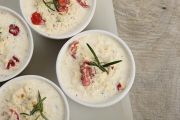 several dishes with casserole - sour cream, tomatoes and fish or other ingredients before baking. dishes with unroasted julienne 