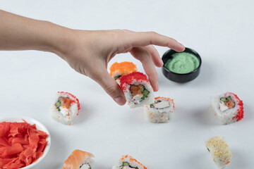 Maki sushi rolls with red caviar served with wasabi sauce