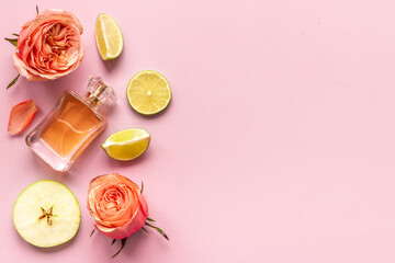 Bottle of perfume with citrus and flowers, top view