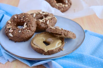 Vegan gluten free bagels topped with sunflower seeds, flax seeds and sesame seeds. Healthy breakfast food. 