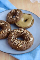 Vegan gluten free bagels topped with sunflower seeds, flax seeds and sesame seeds. Healthy breakfast food. 