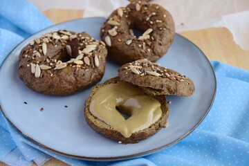 Vegan gluten free bagels topped with sunflower seeds, flax seeds and sesame seeds. Healthy breakfast food. 