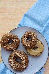 Vegan gluten free bagels topped with sunflower seeds, flax seeds and sesame seeds. Healthy breakfast food. 