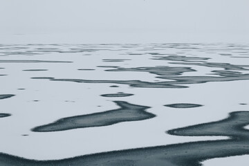 Landscape with the partially frozen river