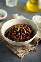 Homemade beef chili con carne with sour cream