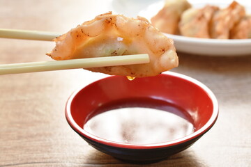 crispy fried Gyoza or Japanese dumpling stuffed mashed pork dipping shoyu sauce on plate