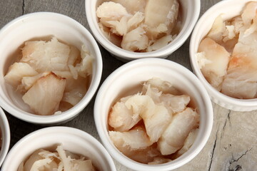 several dishes with raw fresh fish pieces before frying. dishes with unroasted julienne. Sliced...