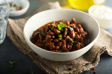 Homemade beef chili con carne with sour cream