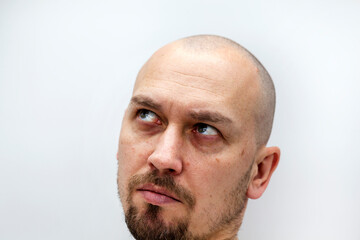 a man's face with a beard and bald, different expressions of emotion,
