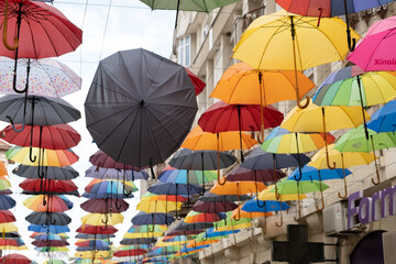 Fototapeta na wymiar A group of different colored umbrella In ROmania in center of Iasi Town in a summer day with sun